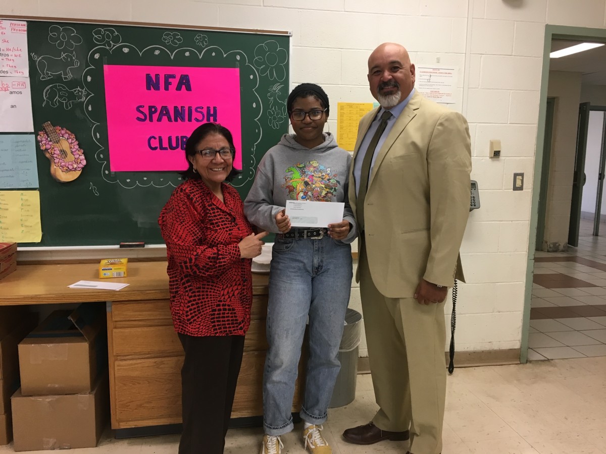 Award recipient from Spanish Club stand with club advisor Mrs. Kennedy and co-principal of NFA Main, Mr. Raul Rodriguez.