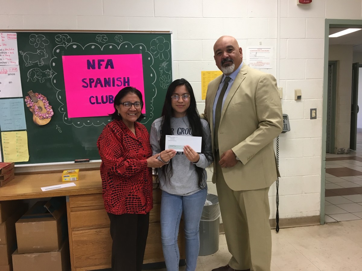 Award recipient from Spanish Club stand with club advisor Mrs. Kennedy and co-principal of NFA Main, Mr. Raul Rodriguez.