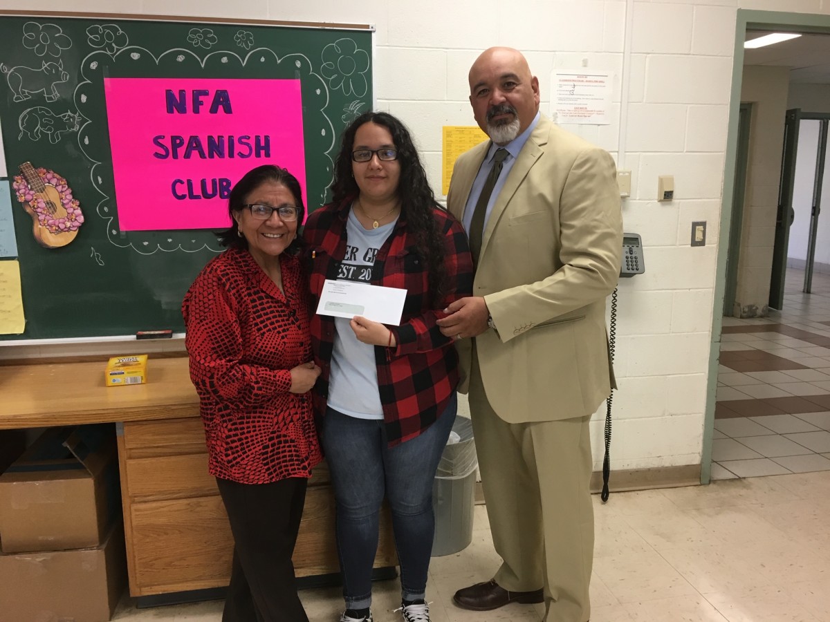 Award recipient from Spanish Club stand with club advisor Mrs. Kennedy and co-principal of NFA Main, Mr. Raul Rodriguez.