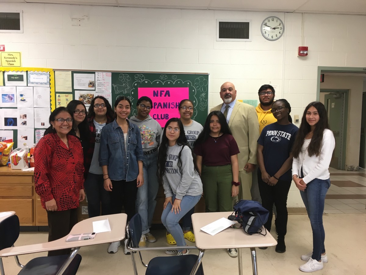 Award recipient from Spanish Club stand with club advisor Mrs. Kennedy and co-principal of NFA Main, Mr. Raul Rodriguez.