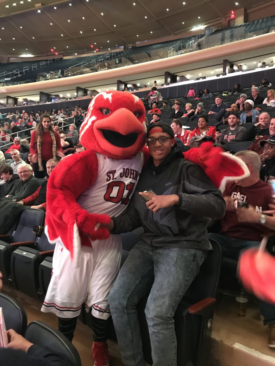 Student poses with mascot