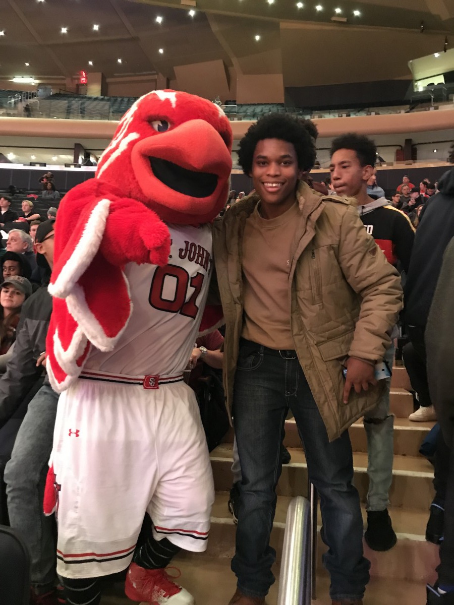 Student poses with mascot