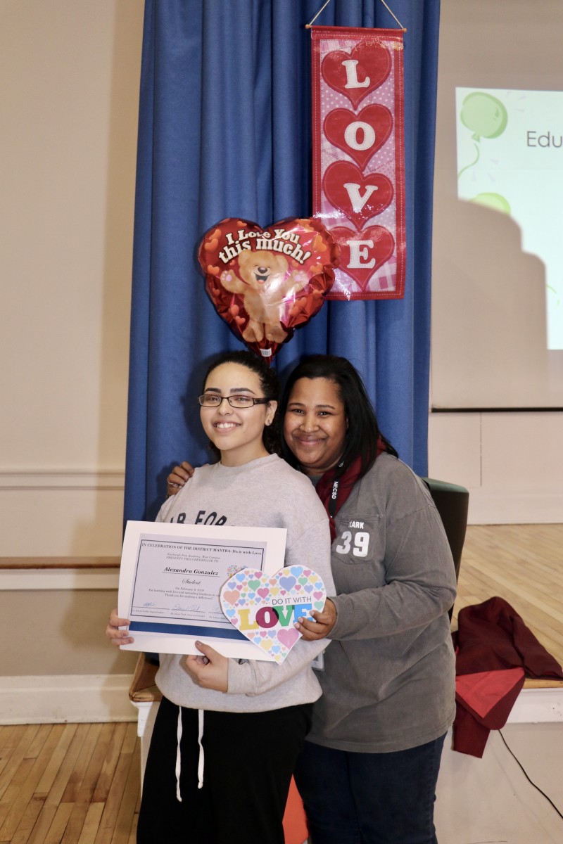 Co-Principal, Ms. Ebony Clark standing with Scholar winner for the week