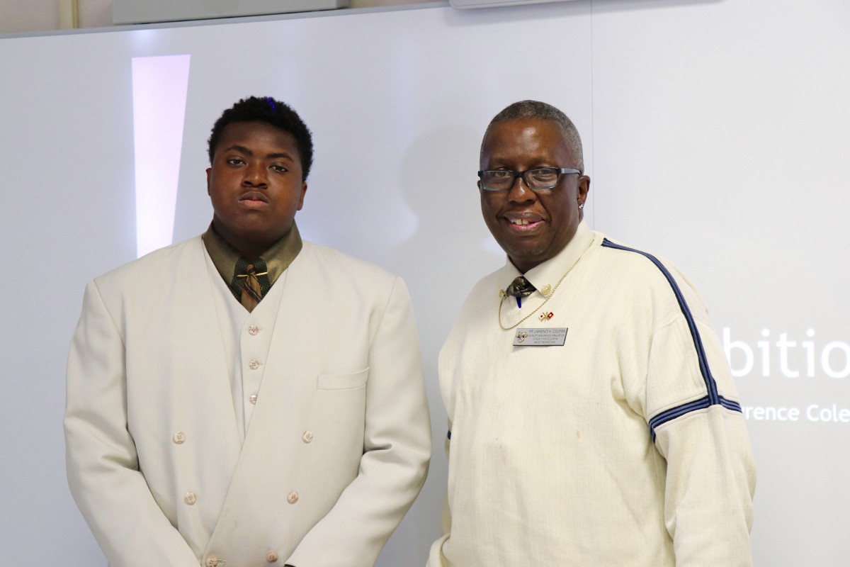 NFA West student poses with parent who came to watch his Exhibition presentation