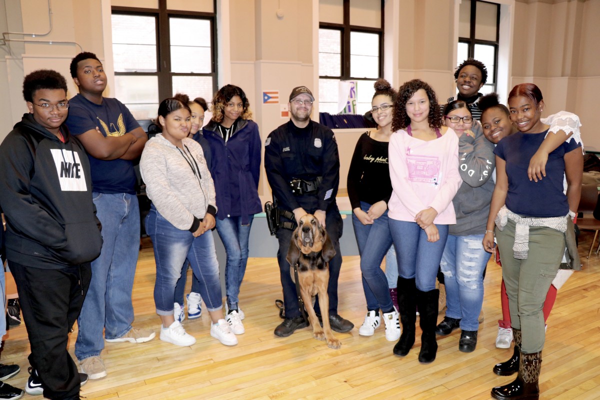 Students poses with office and K9