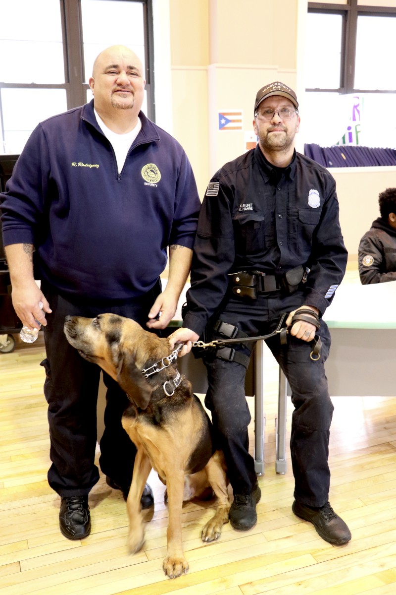 Mr. Rudy Rodriguez poses with office and K9