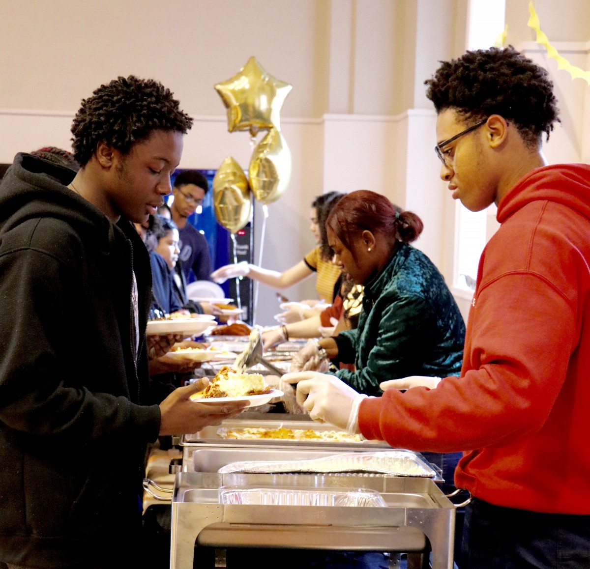 Students serve each other for International Celebration