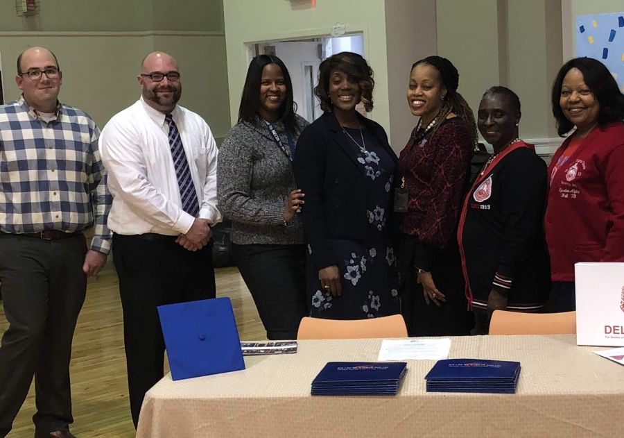 Representatives and school personnel pose for a photo.