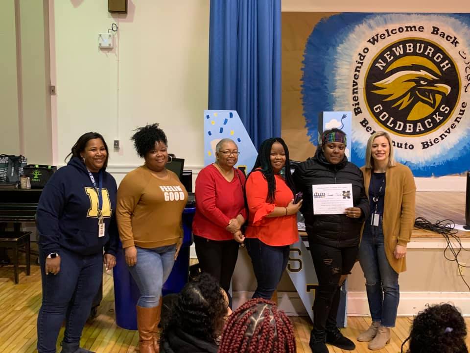 Student recipient, Juanita Clanton poses with friends, family, and teachers for a photo.