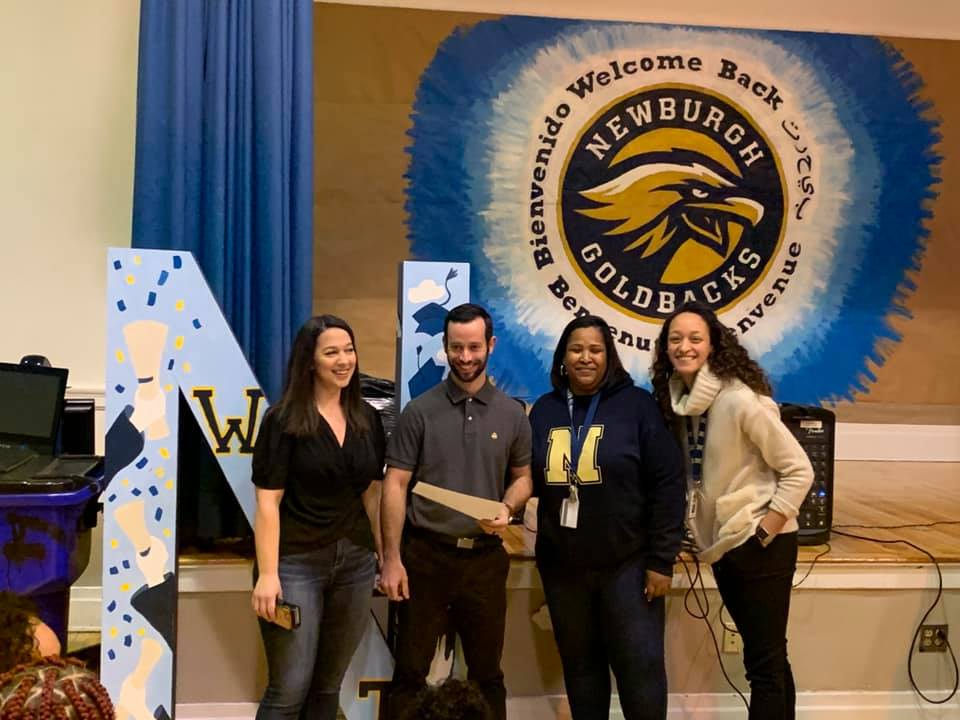 Teacher recipient, Brian Carroll poses for a photo with his wife, principal, and fellow teacher.