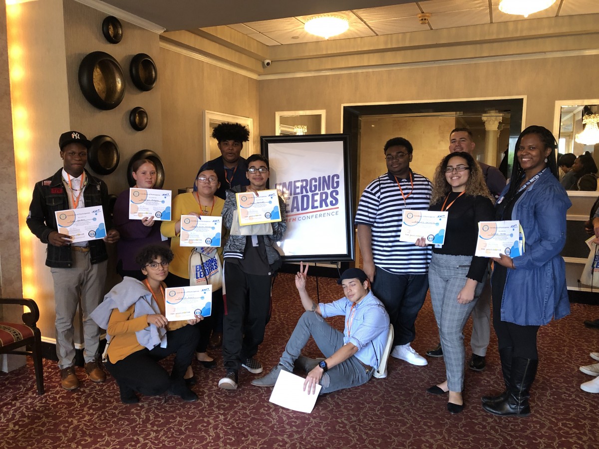 Participants stand for a photo holding their certificates.