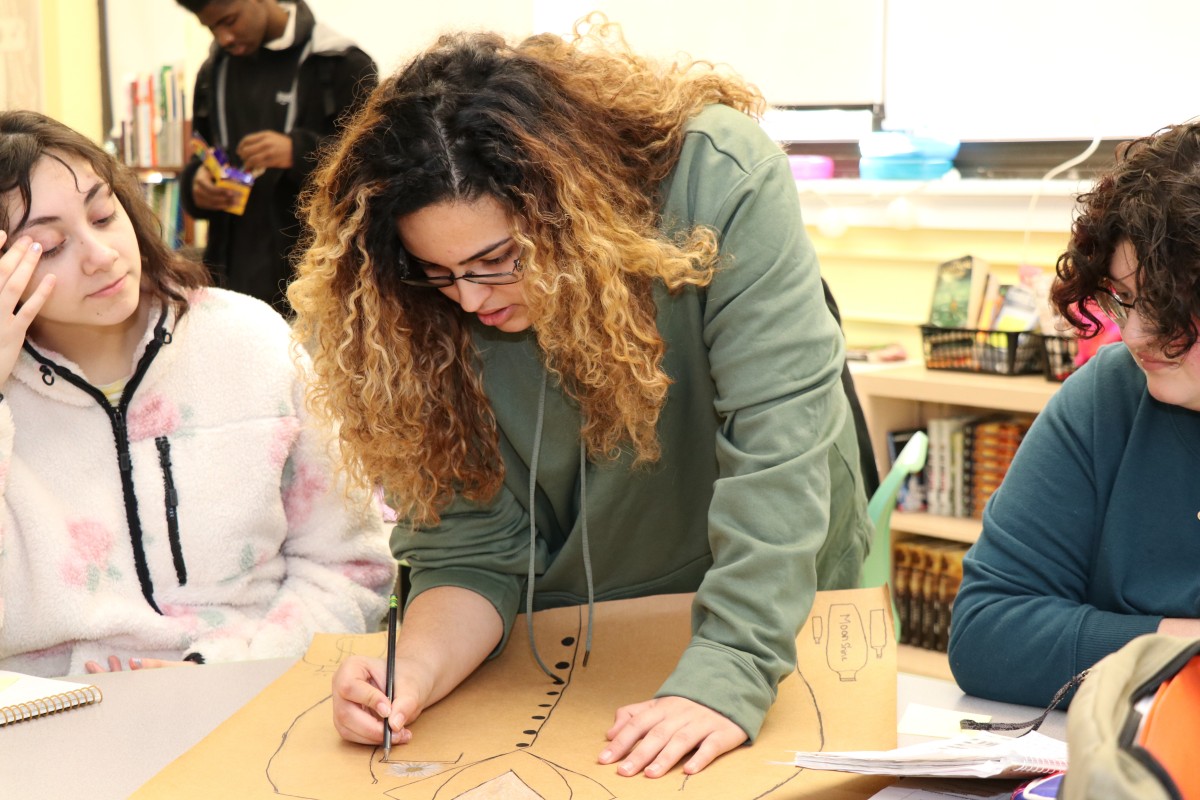 Students critiquing the work of their classmates.