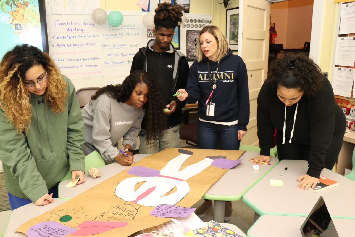 Students critiquing the work of their classmates.