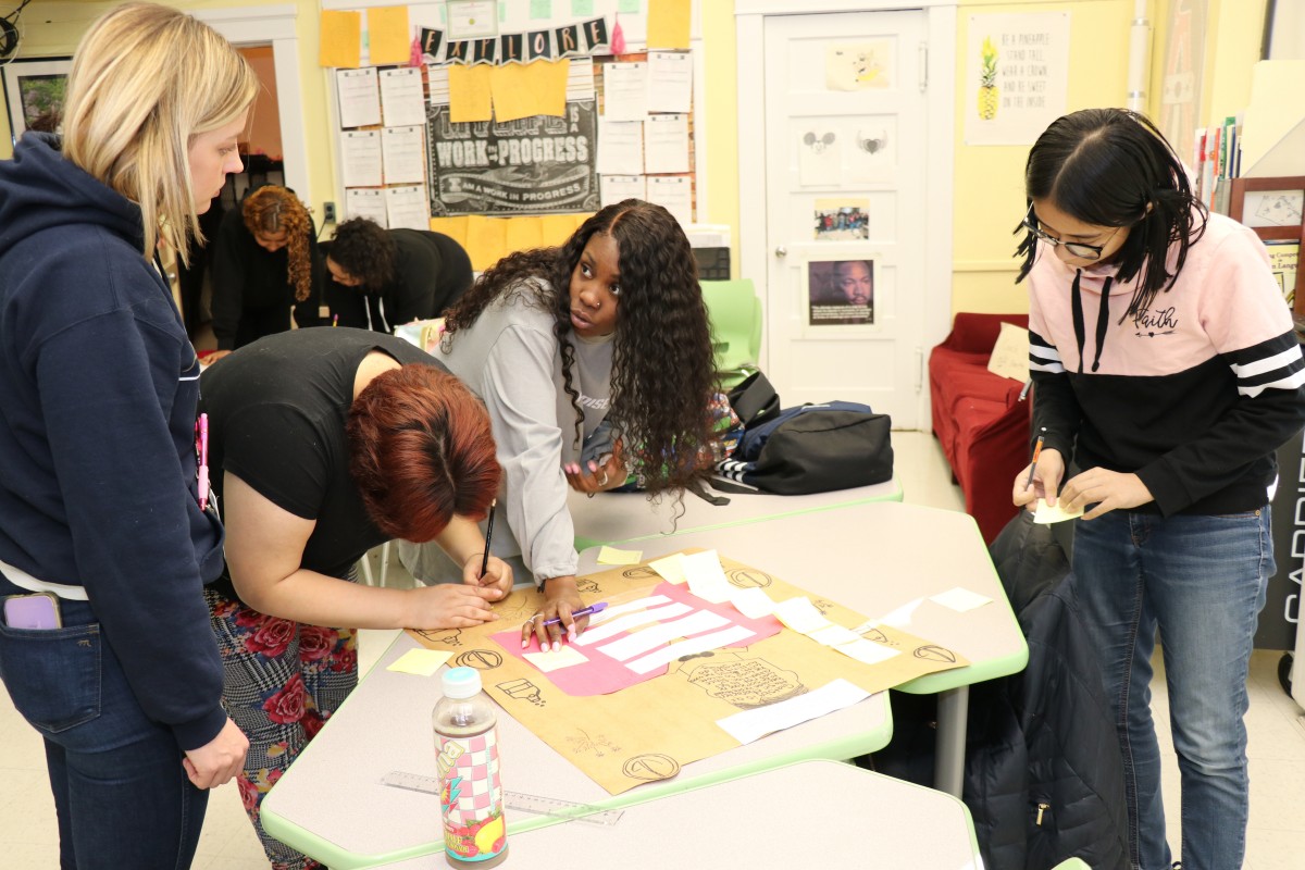 Students critiquing the work of their classmates.