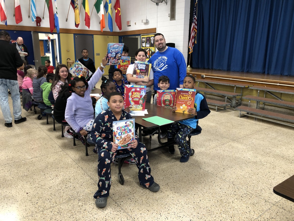 Meadow Hill students pose for a photo with their principal.