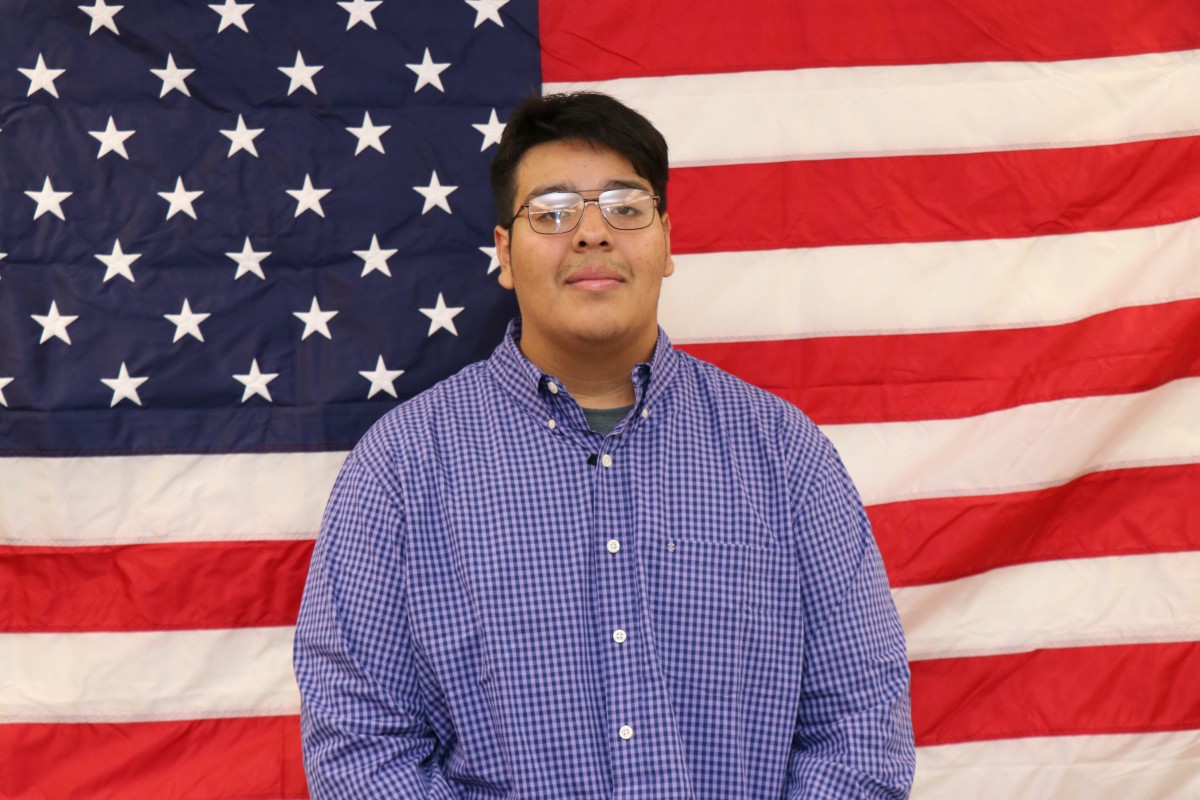 Student poses for photo after winning mock election.