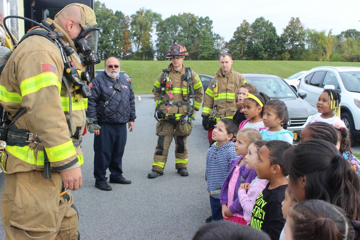 Firefighter talking to students