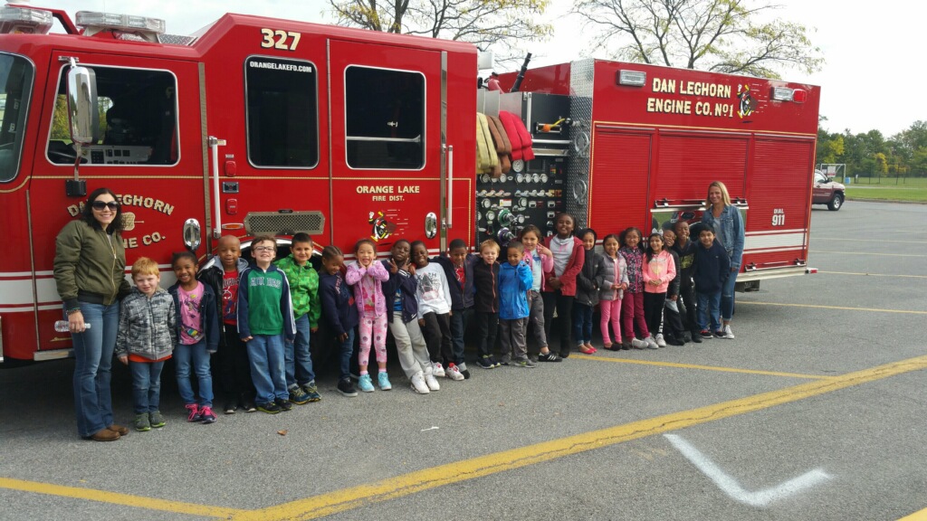 Students standing in front of firetruck