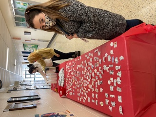 Faculty/staff selecting their sticker and picking up a treat.