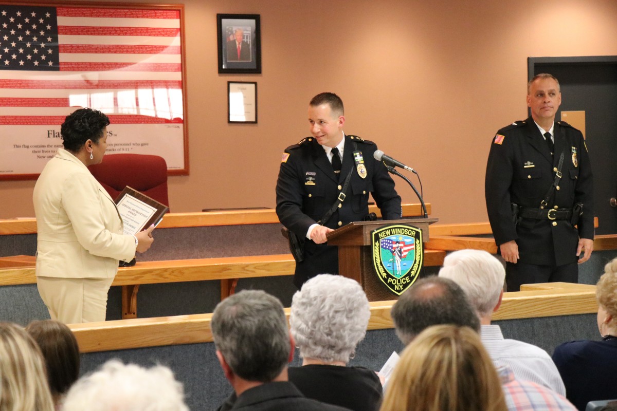 Mrs. Briscoe-Perez accepts the award from Chief Robert Doss.