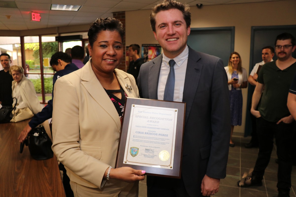 Mrs. Briscoe-Perez poses with Senator James Skoufis and her award.