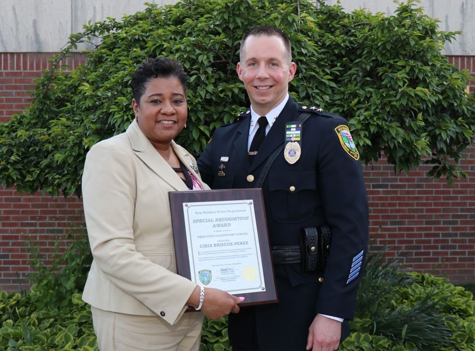 Mrs. Briscoe-Perez stands with Chief Robert Doss.