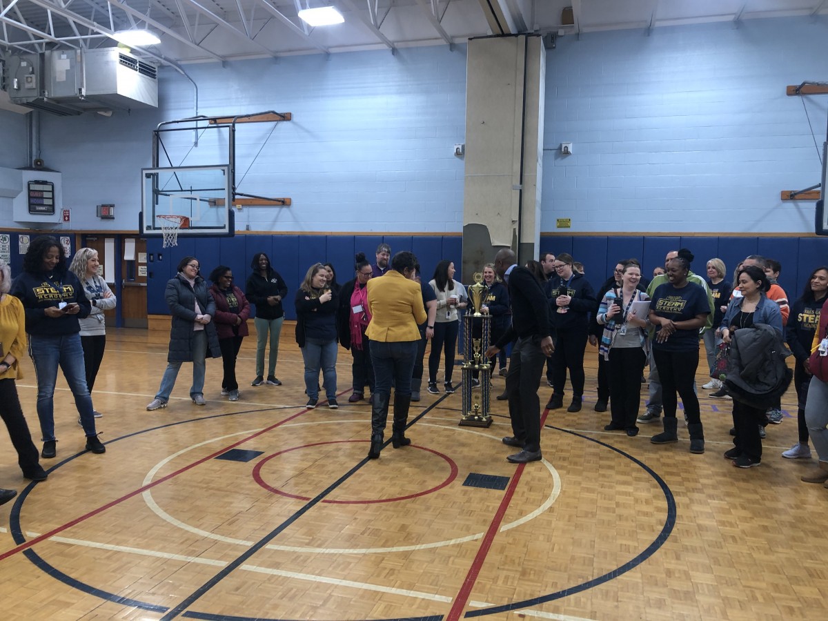 Building principal Mrs. Ciria Briscoe-Perez accepts the trophy.