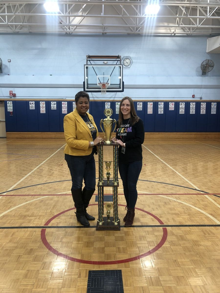 Building principal Mrs. Ciria Briscoe-Perez and Assistant Principal, Ms. Eileen Cruz pose for a photo with the Attendance Trophy.